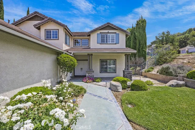 a view of a house with table and chairs in a patio