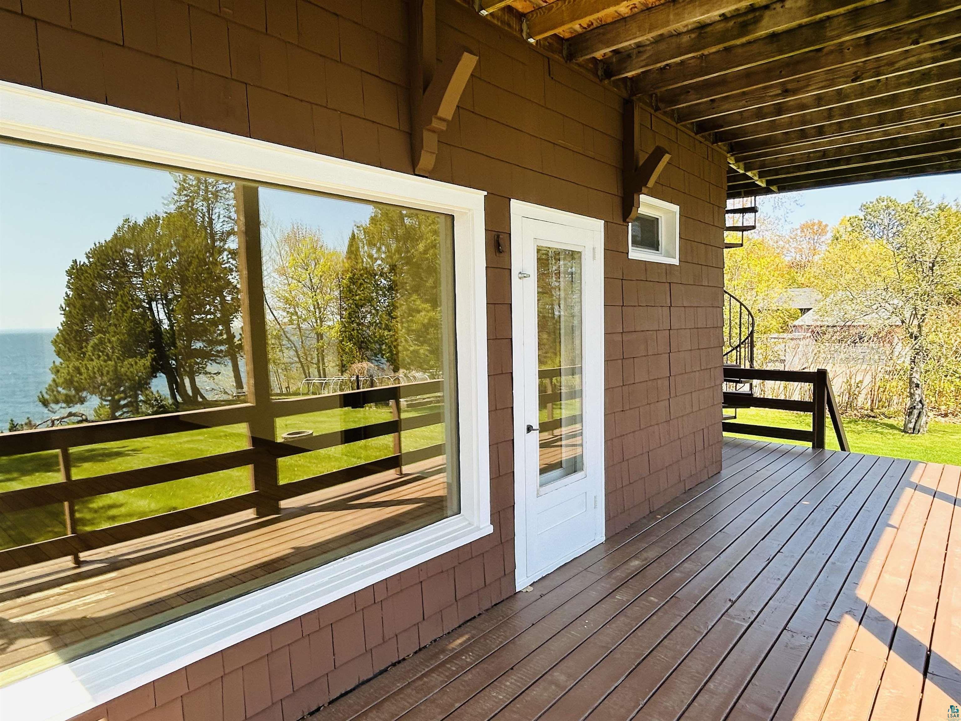 5090 London Road, Unit 1 Duluth, MN 55804 - Photo 39 of 54 Expansive deck with brown wood-finish flooring, shingle siding, and a white framed glass entry door
