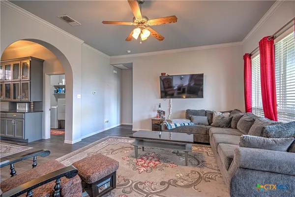 a living room with furniture and a flat screen tv