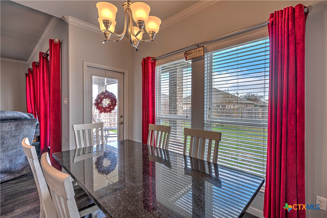 504 Coventry Drive Temple, TX 76502 - Photo 20 of 30 a view of a dining room with furniture and chandelier