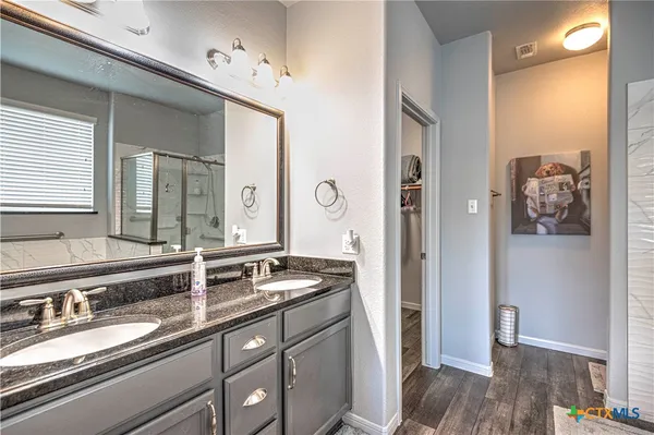 a bathroom with a sink double vanity and a mirror