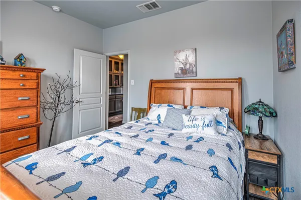 a bedroom with a bed and a dresser in it