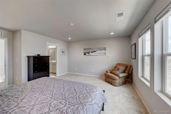 a bedroom with a bed and couch