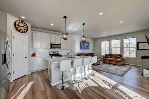 a view of kitchen with sink and wooden floor