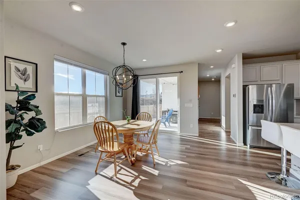 a view of a dining room with furniture window and wooden floor