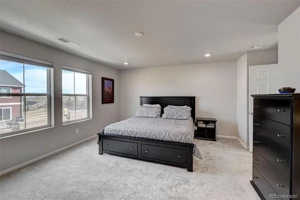 a spacious bedroom with a bed and a window