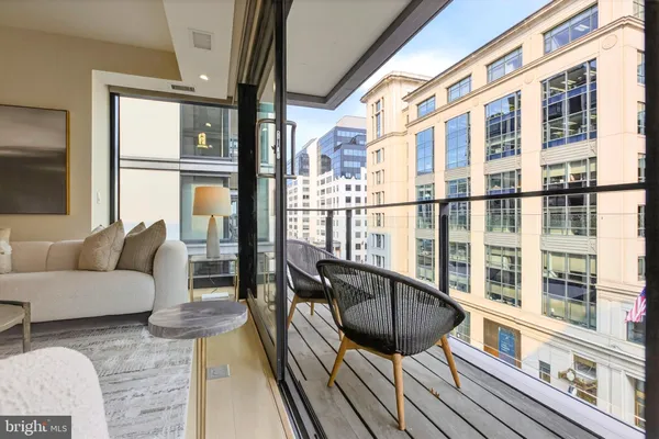 a living room with furniture and a floor to ceiling window