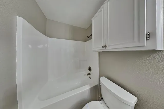 a bathroom with a toilet and bathtub