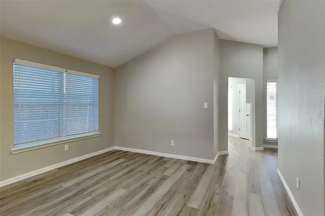 a view of a room with wooden floor and window