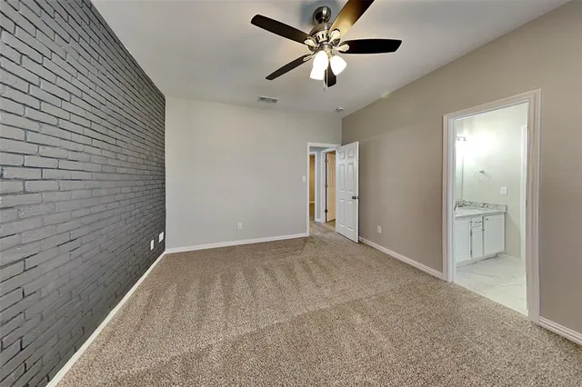 an empty room with fan and a ceiling fan