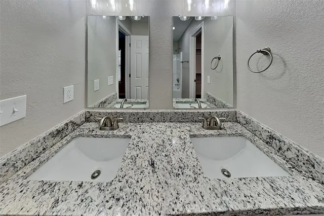 a bathroom with a bathtub sink and mirror