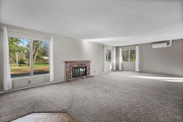 a kitchen with white cabinets and wooden floor