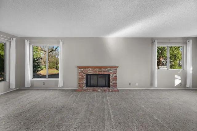 a kitchen with granite countertop white cabinets and white stainless steel appliances