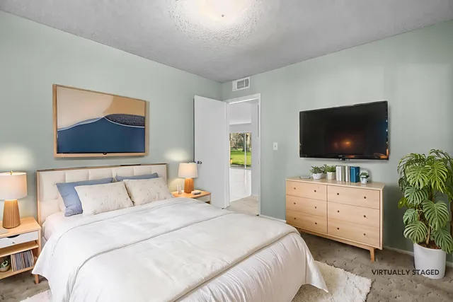 a view of dirt yard with green space