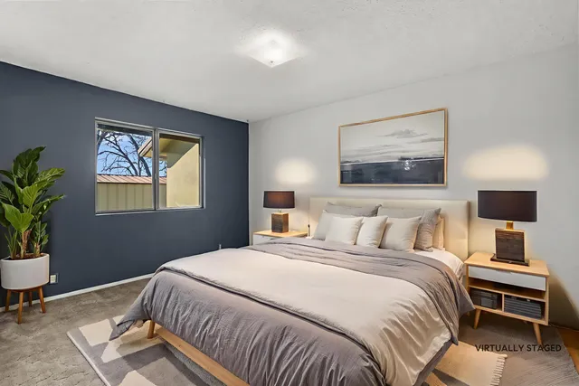 a view of a backyard with wooden fence and a bench