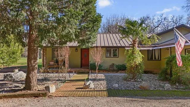 an empty room with windows and fireplace