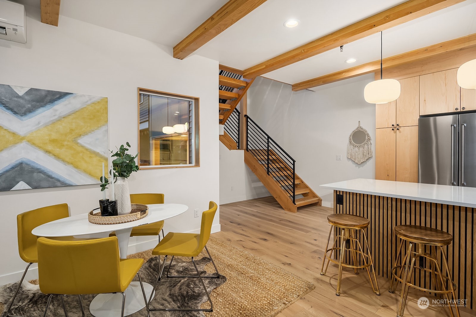 911 14th Avenue, Unit A Seattle, WA 98122 - Photo 13 of 33 a living room with dining table and wooden floor