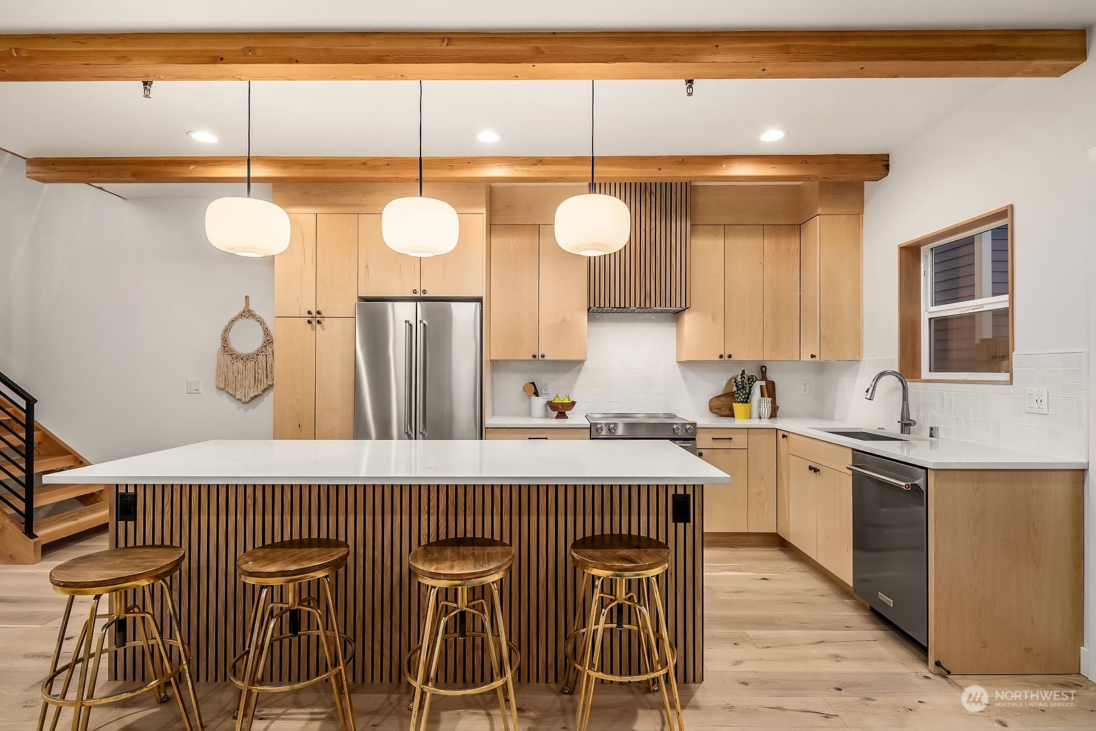 911 14th Avenue, Unit A Seattle, WA 98122 - Photo 3 of 33 a kitchen with a table a sink and cabinets