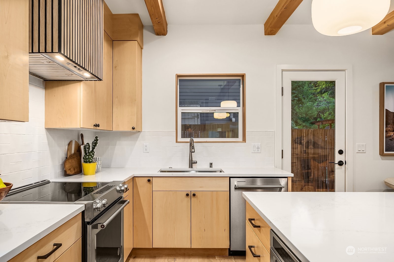 911 14th Avenue, Unit A Seattle, WA 98122 - Photo 4 of 33 a kitchen with a sink a stove cabinets and a window