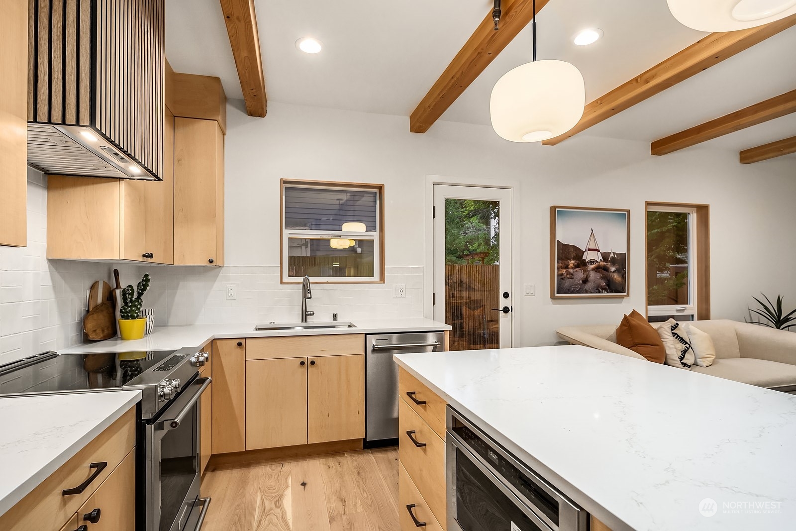 911 14th Avenue, Unit A Seattle, WA 98122 - Photo 6 of 33 a kitchen with a sink a stove and cabinets