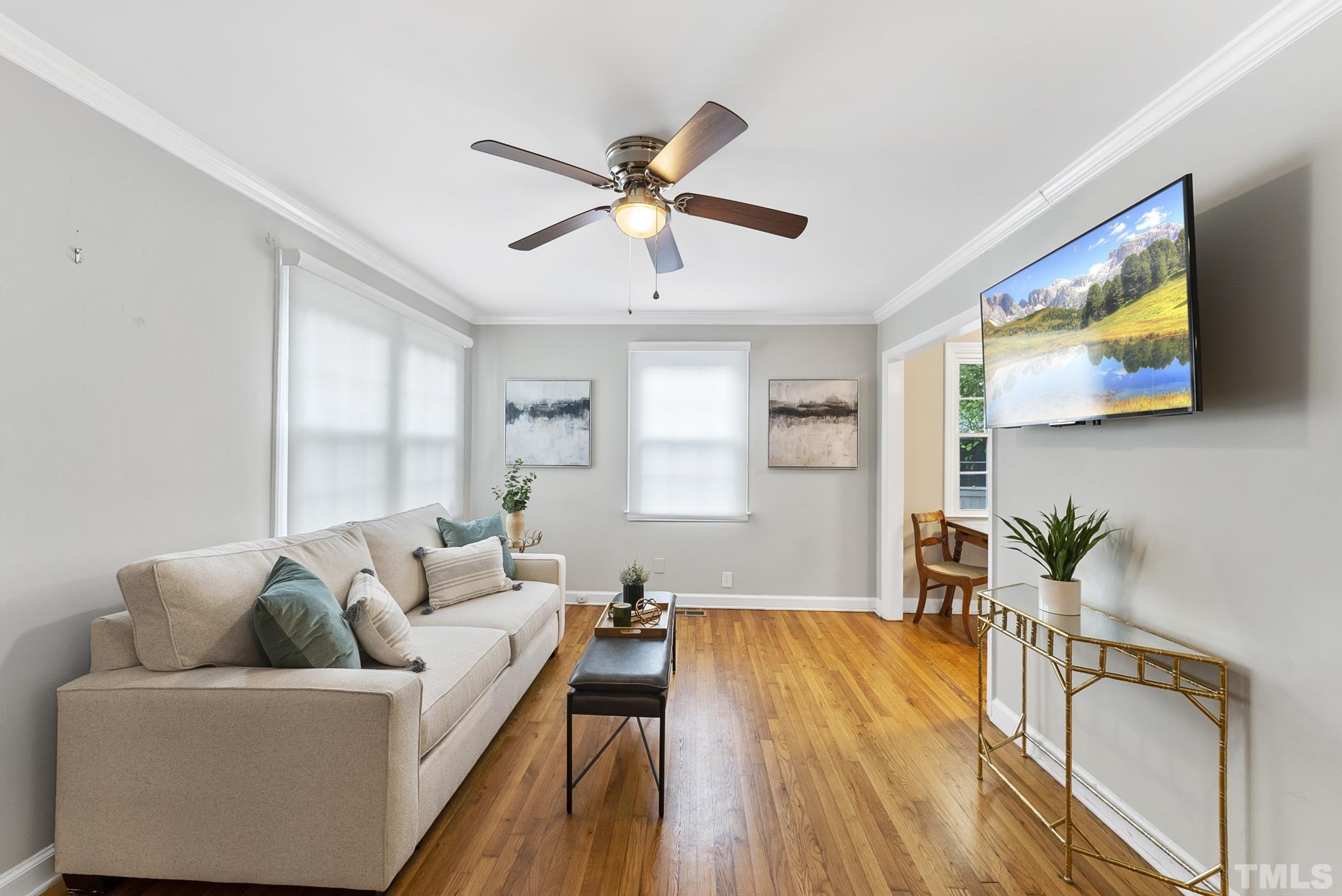 808 Young Street Raleigh, NC 27608 - Photo 1 of 26 a living room with furniture and a flat screen tv