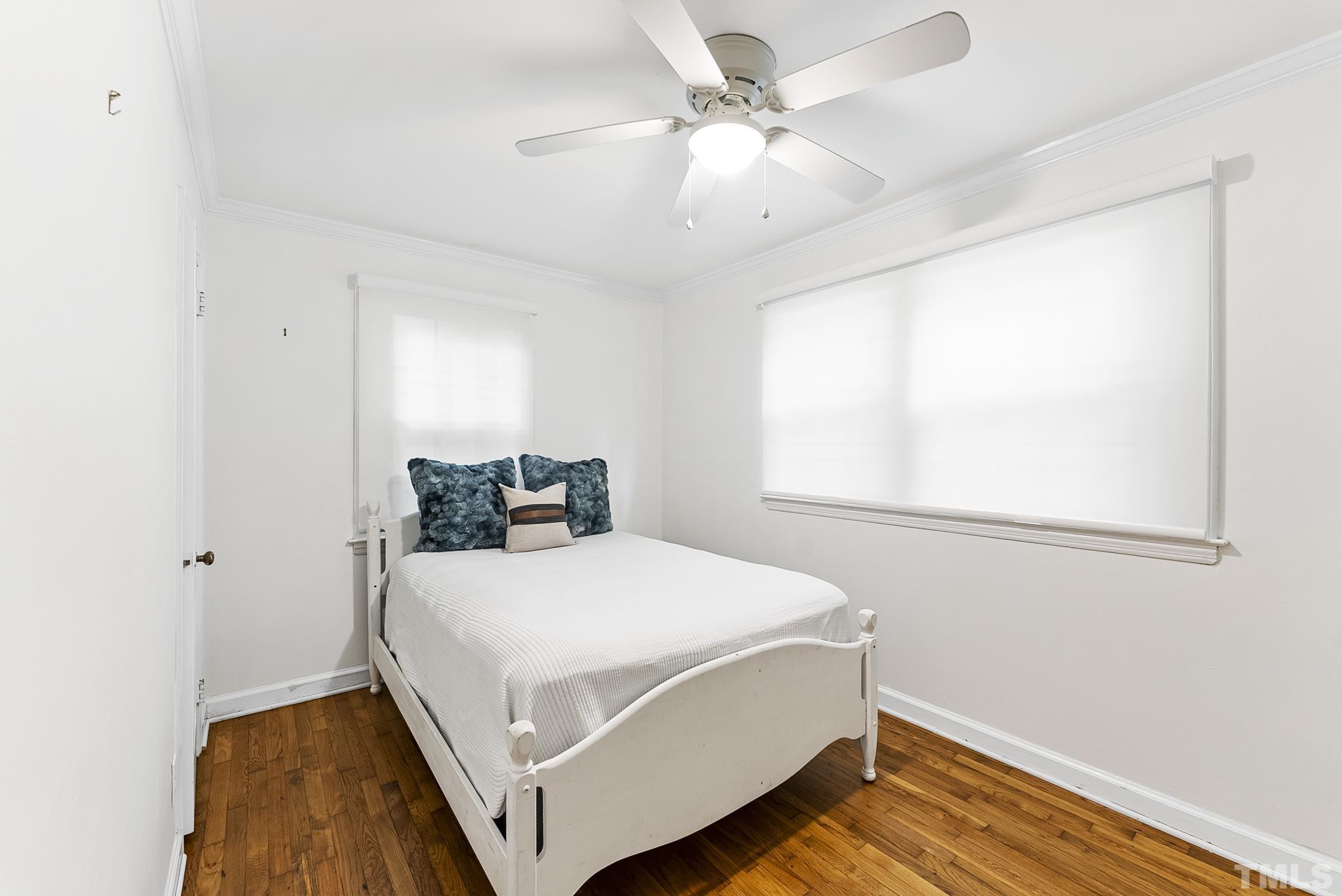 808 Young Street Raleigh, NC 27608 - Photo 13 of 26 a bedroom with a bed and a window