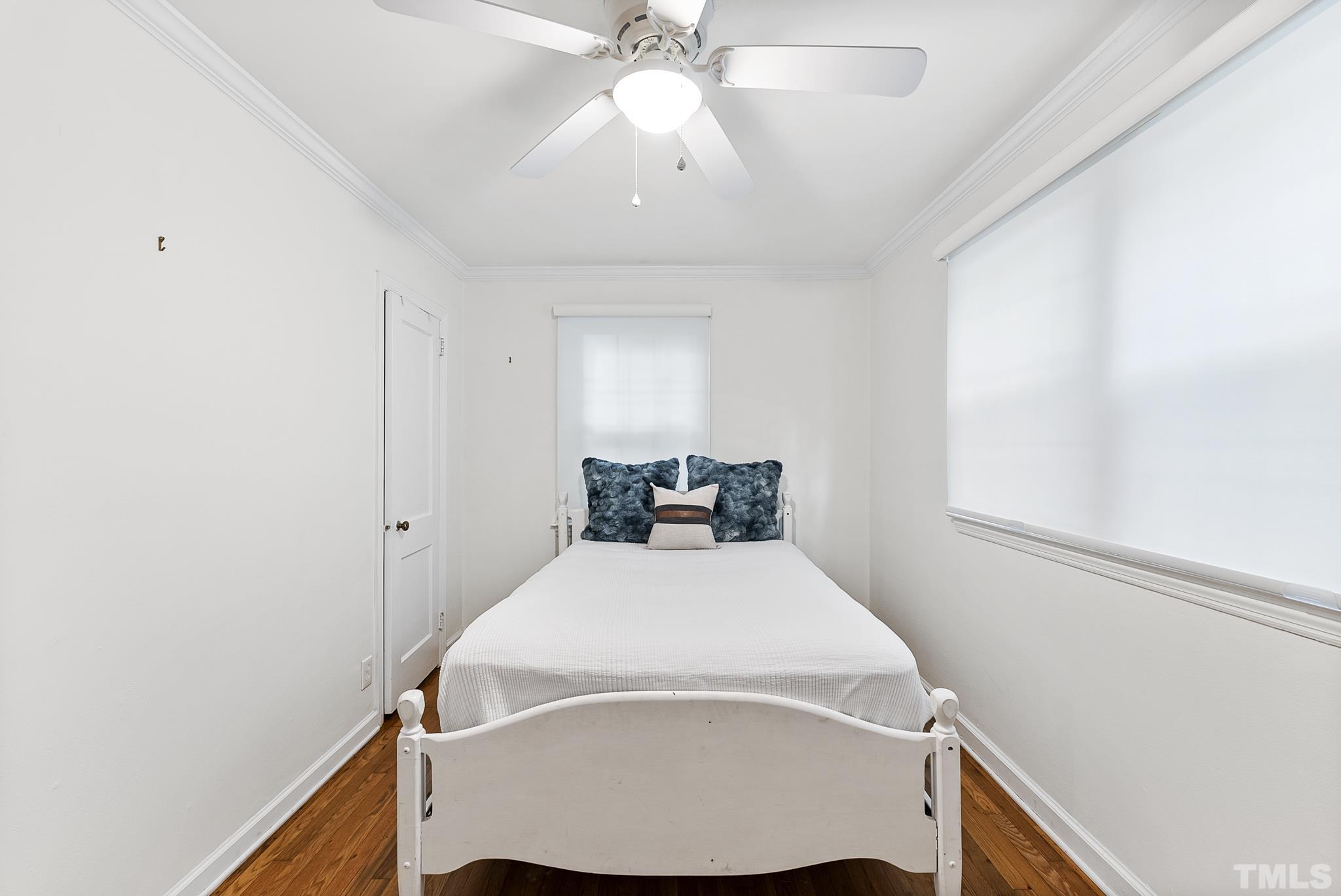 808 Young Street Raleigh, NC 27608 - Photo 14 of 26 a bed room with a bed and a chandelier