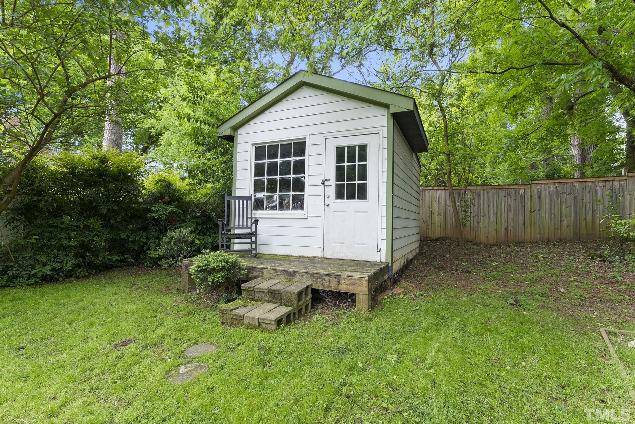 808 Young Street Raleigh, NC 27608 - Photo 20 of 26 a backyard of a house with table and chairs