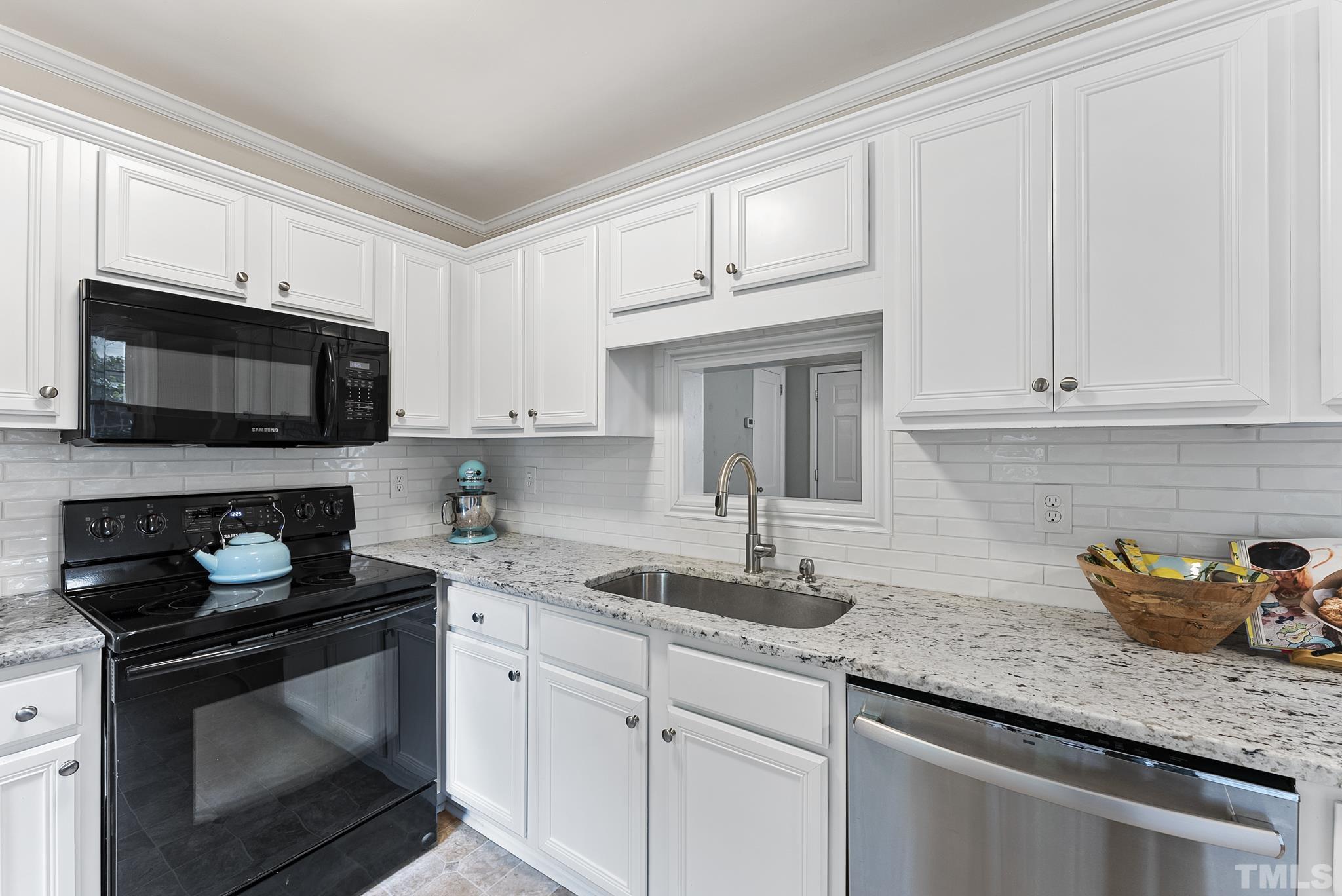 808 Young Street Raleigh, NC 27608 - Photo 8 of 26 a kitchen with granite countertop white cabinets sink and stainless steel appliances