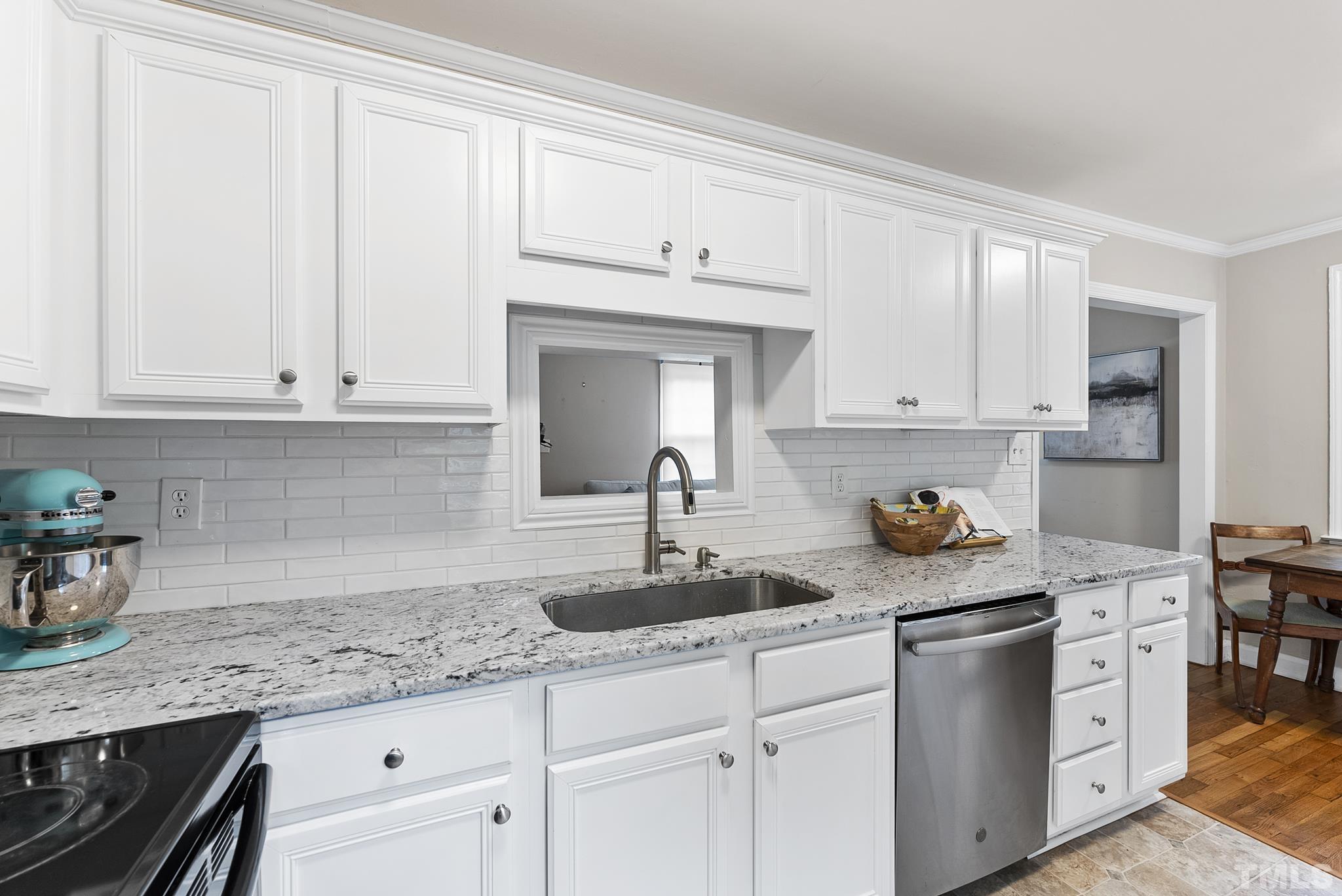 808 Young Street Raleigh, NC 27608 - Photo 10 of 26 a kitchen with stainless steel appliances granite countertop white cabinets and a sink