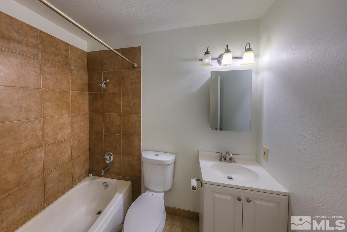 3504 Sun Cloud Circle Reno, NV 89506 - Photo 15 of 26 a bathroom with a sink toilet mirror and shower