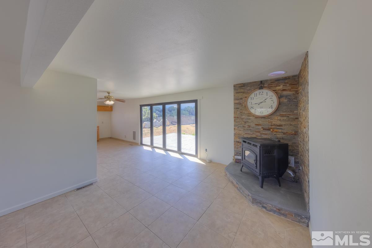 3504 Sun Cloud Circle Reno, NV 89506 - Photo 4 of 26 a view of an empty room with a fireplace and a window