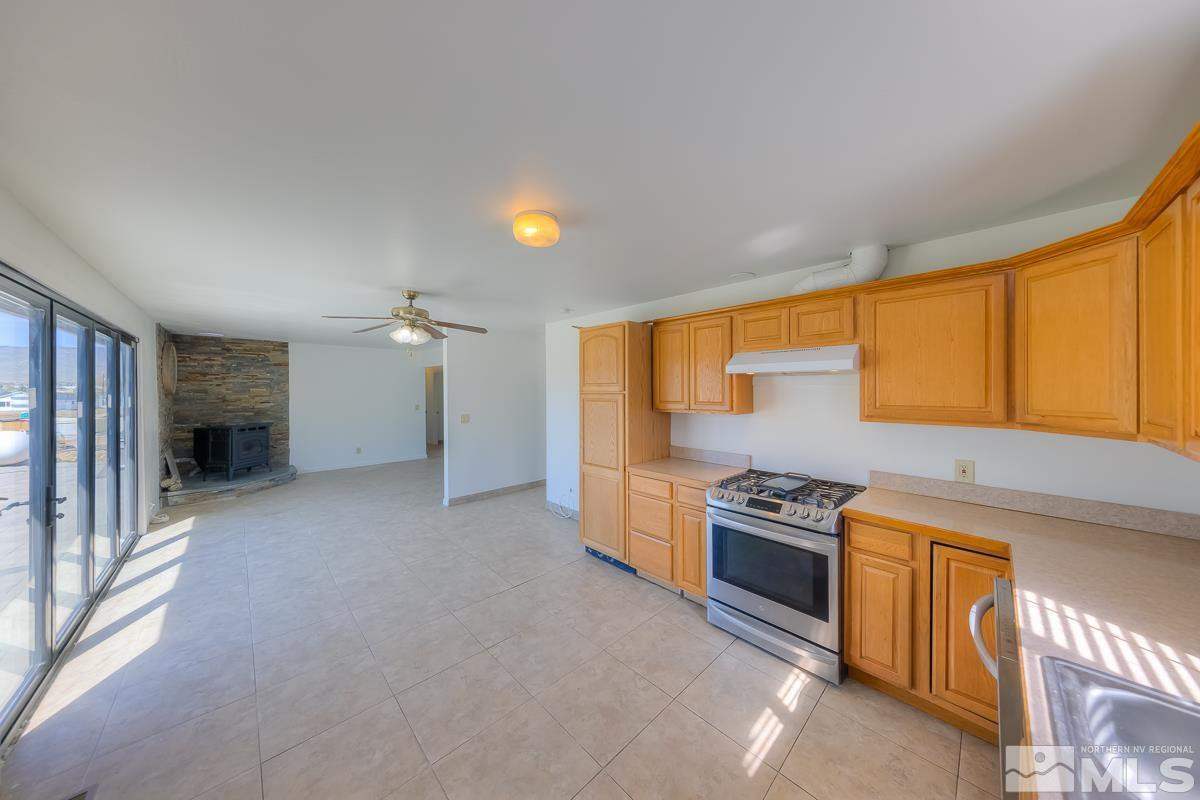 3504 Sun Cloud Circle Reno, NV 89506 - Photo 9 of 26 a kitchen with a stove a sink and a refrigerator