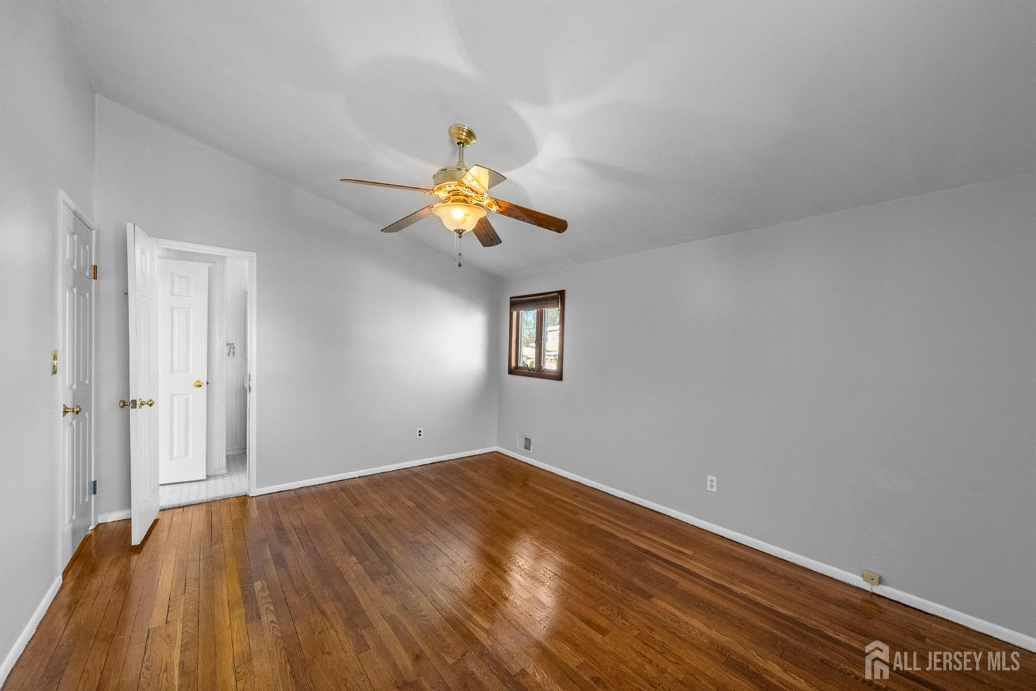 9 Piedmont Drive Old Bridge, NJ 08857 - Photo 20 of 40 a view of empty room with wooden floor and ceiling fan