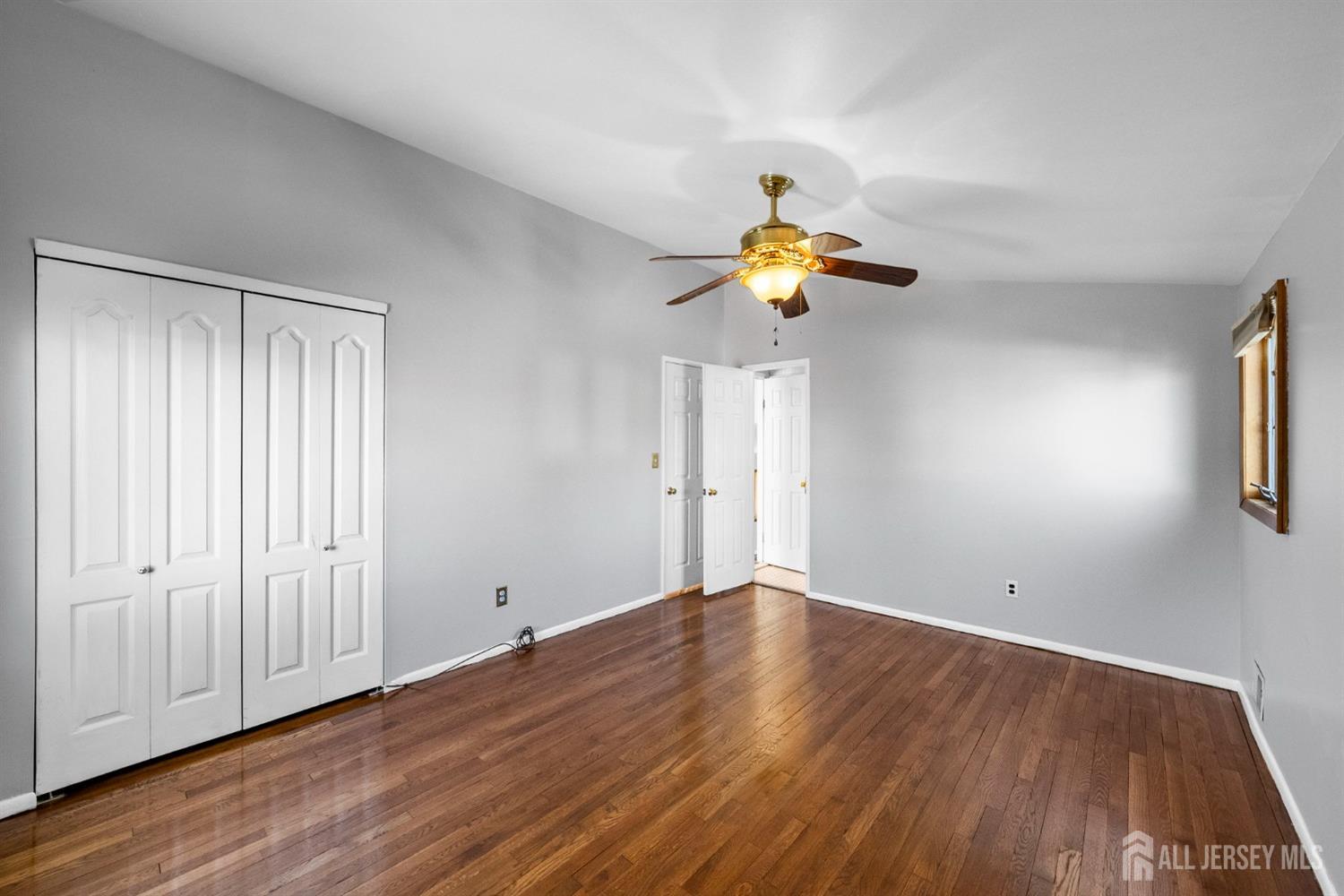 9 Piedmont Drive Old Bridge, NJ 08857 - Photo 21 of 40 a view of an empty room with wooden floor and a window