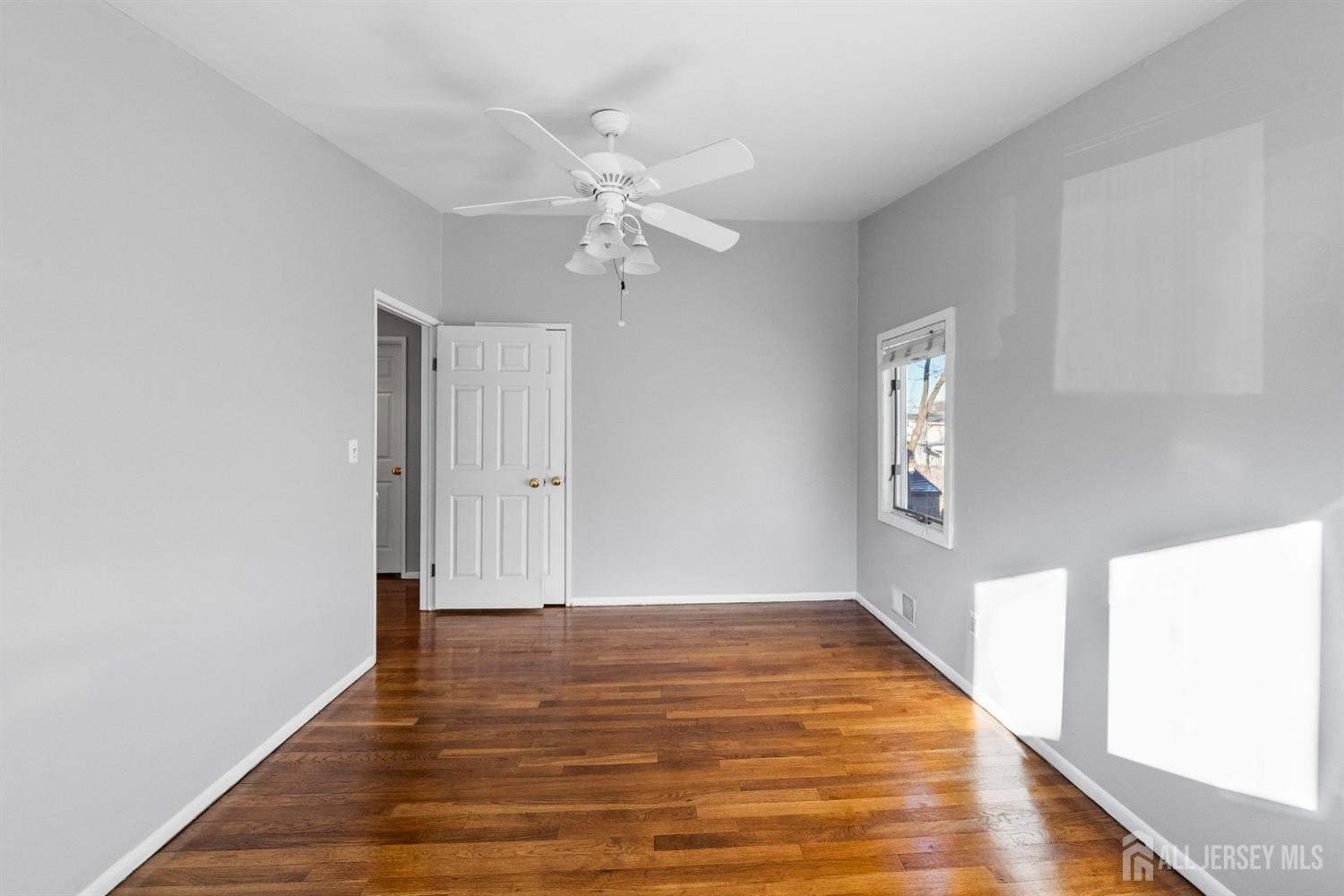 9 Piedmont Drive Old Bridge, NJ 08857 - Photo 25 of 40 a view of an empty room with wooden floor and a window