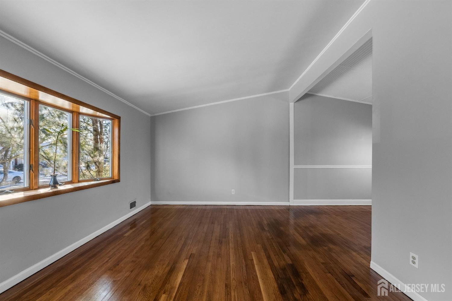 9 Piedmont Drive Old Bridge, NJ 08857 - Photo 9 of 40 a view of an empty room with wooden floor and a window