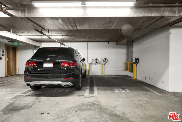 a view of garage with a car parked in it