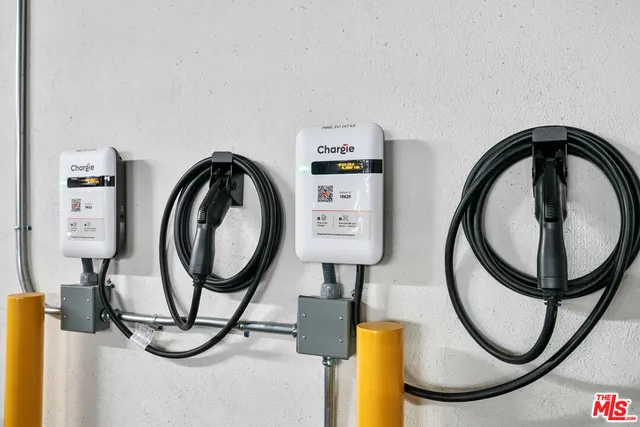 a picture of a room with washer and a mirror