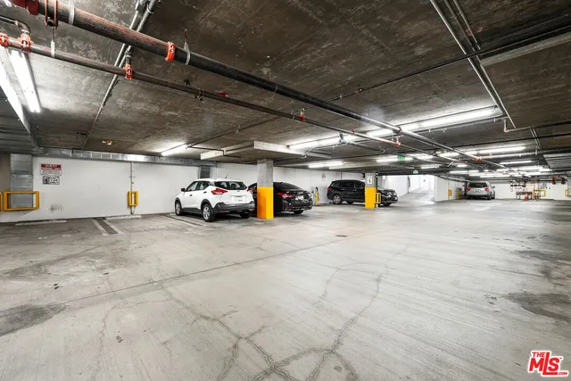 a view of parking garage with cars