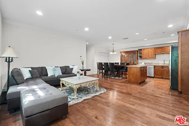 a living room with furniture and kitchen view