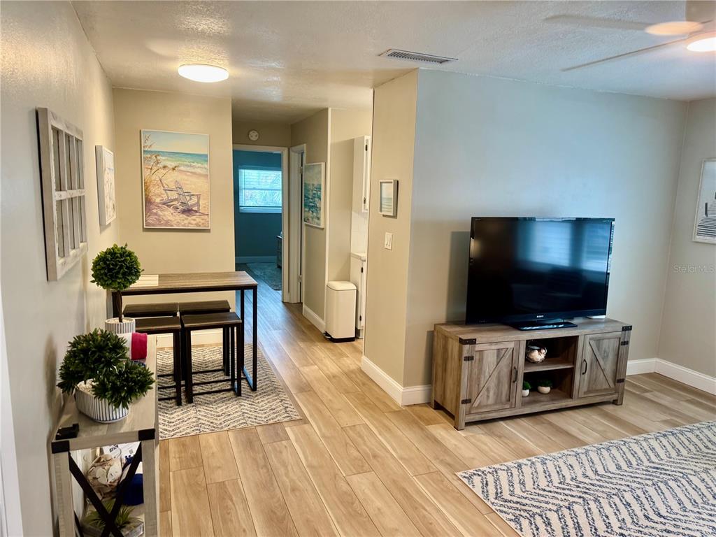 10 164th Avenue, Unit 11 Redington Beach, FL 33708 - Photo 13 of 30 a living room with furniture and a flat screen tv