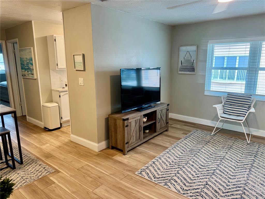 10 164th Avenue, Unit 11 Redington Beach, FL 33708 - Photo 14 of 30 a living room with a flat screen tv and a window