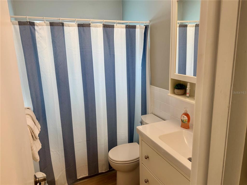 10 164th Avenue, Unit 11 Redington Beach, FL 33708 - Photo 24 of 30 a bathroom with a toilet a sink and a shower