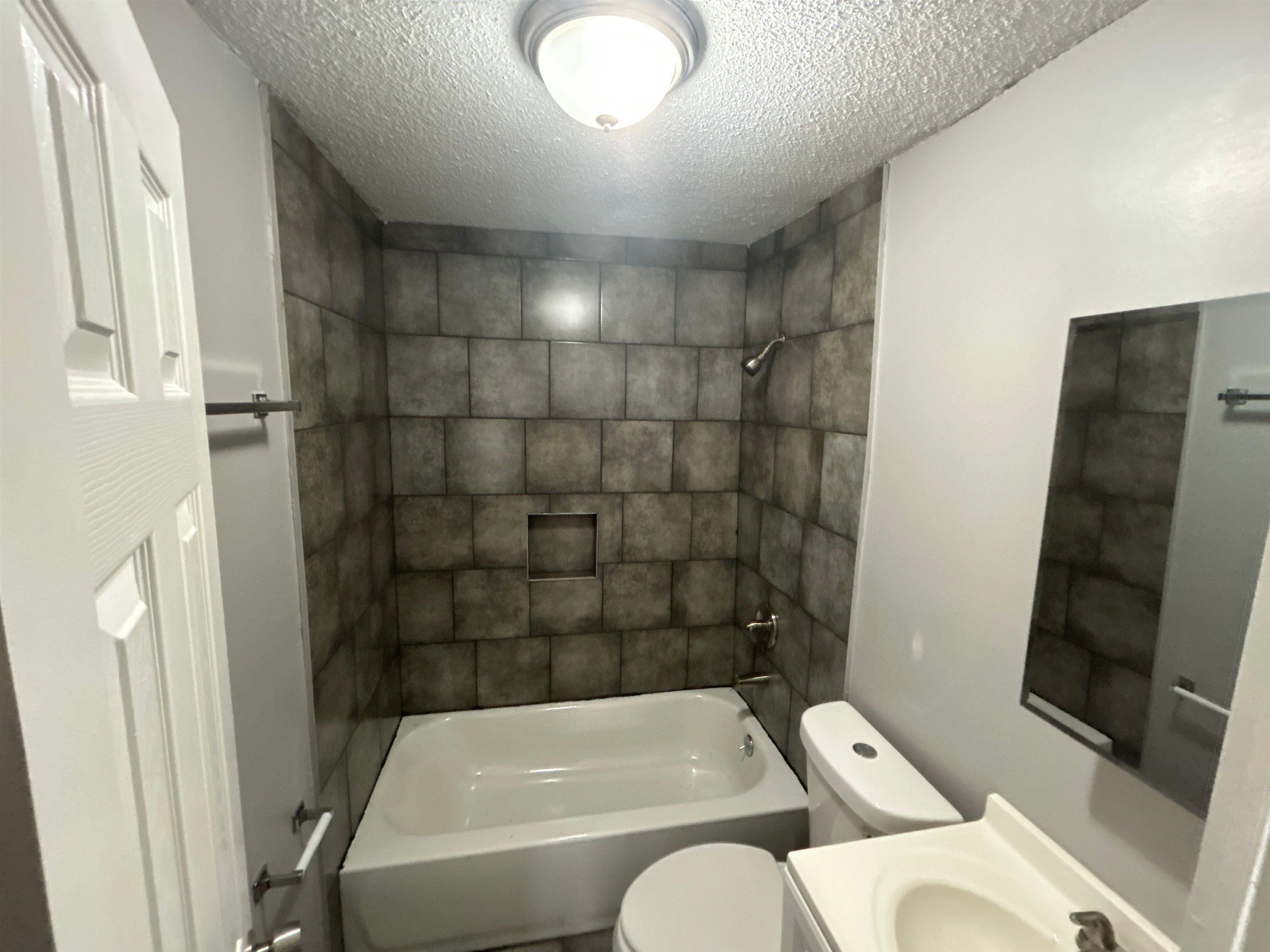 3447 Cook Road Memphis, TN 38109 - Photo 3 of 7 Bathroom featuring vanity, shower / bathtub combination, and a textured ceiling