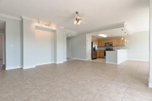 a large kitchen with a stove top oven and cabinets