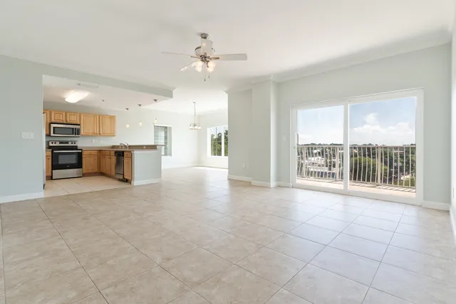 a kitchen with stainless steel appliances granite countertop a refrigerator and a stove top oven