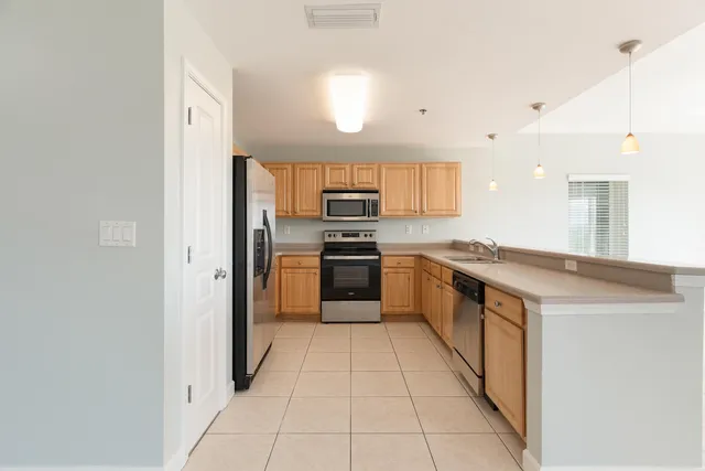 a kitchen with cabinets appliances and a sink