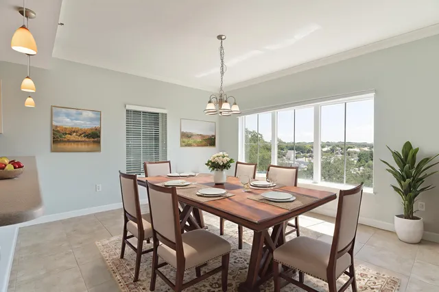 a view of a livingroom with a chandelier fan and windows