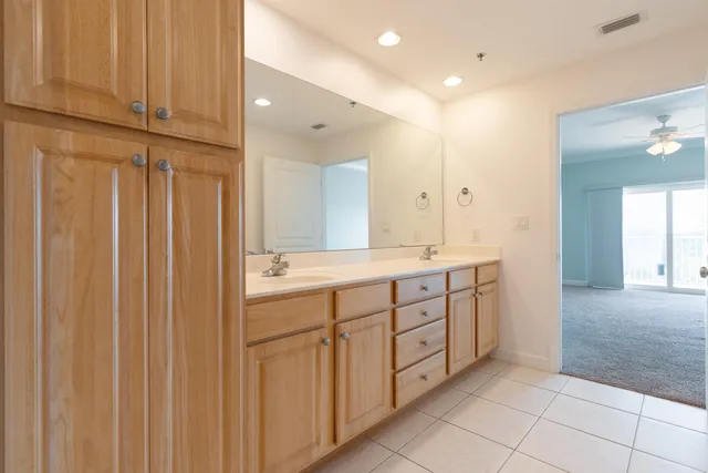 a bedroom with a large bed and a potted plant